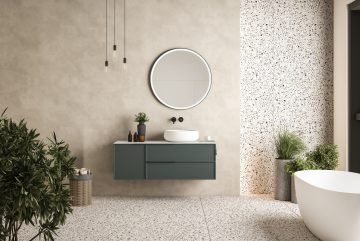 Intérieur de salle de bain minimaliste moderne, meuble de salle de bain vert, évier blanc, vanité en bois, plantes d'intérieur, accessoires de salle de bain, baignoire blanche, mur en béton, revêtement de sol en terrazzo.